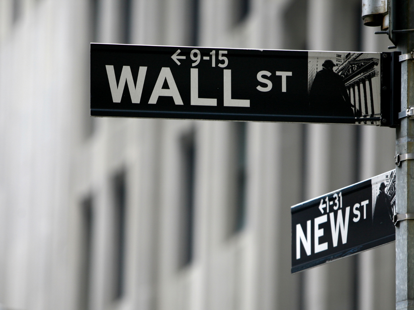 a black and white photo of the famous wall street sign post