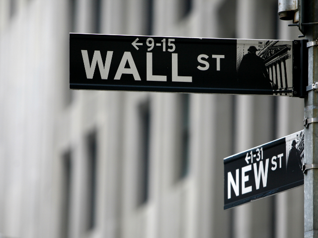 a black and white photo of the famous wall street sign post