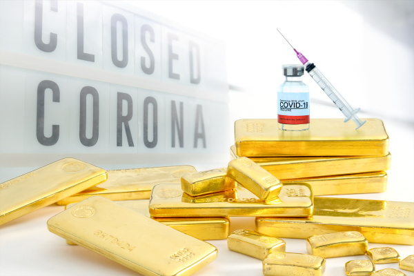 Covid 19 vaccine placed ontop of Perth Mint gold bars