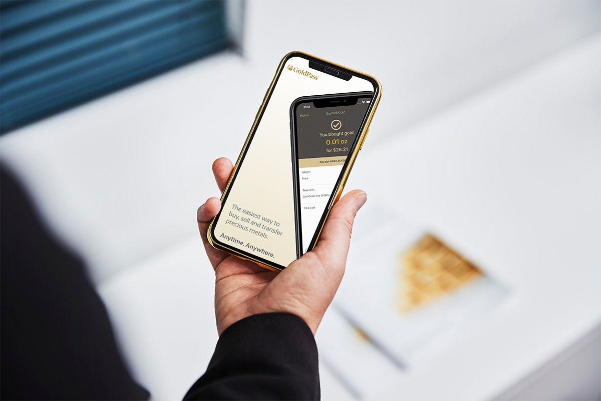 a person holding a phone with the GoldPass app open