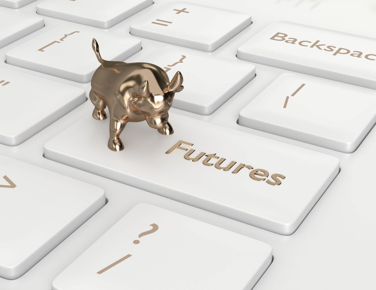 a golden bull standing on a keyboard with the word 'future' on one of the keys