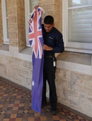 a Perth Mint security guard holding the Australian flag
