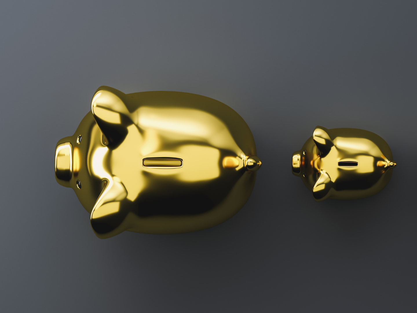 a birdseye view of a large and a small gold piggy bank