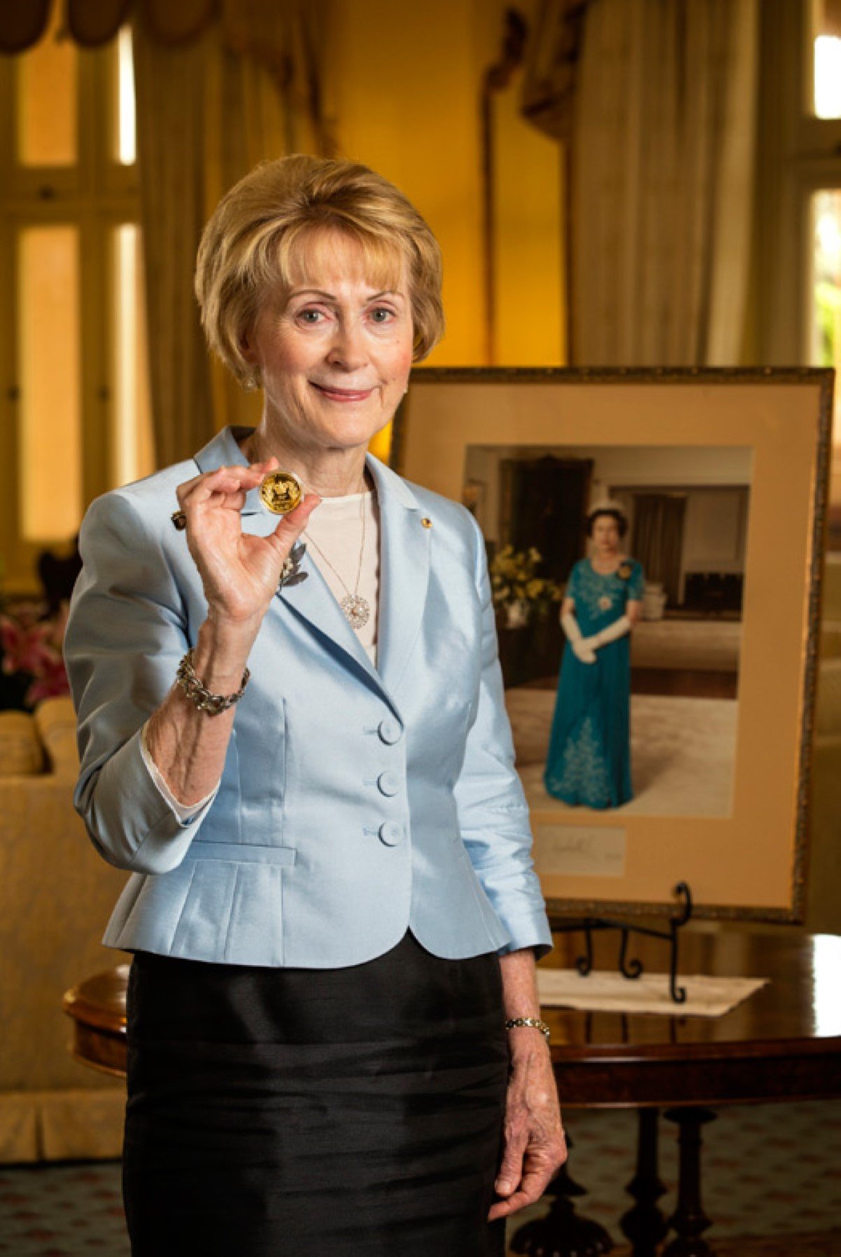 The Honourable Kerry Sanderson holding a Perth Mint coin