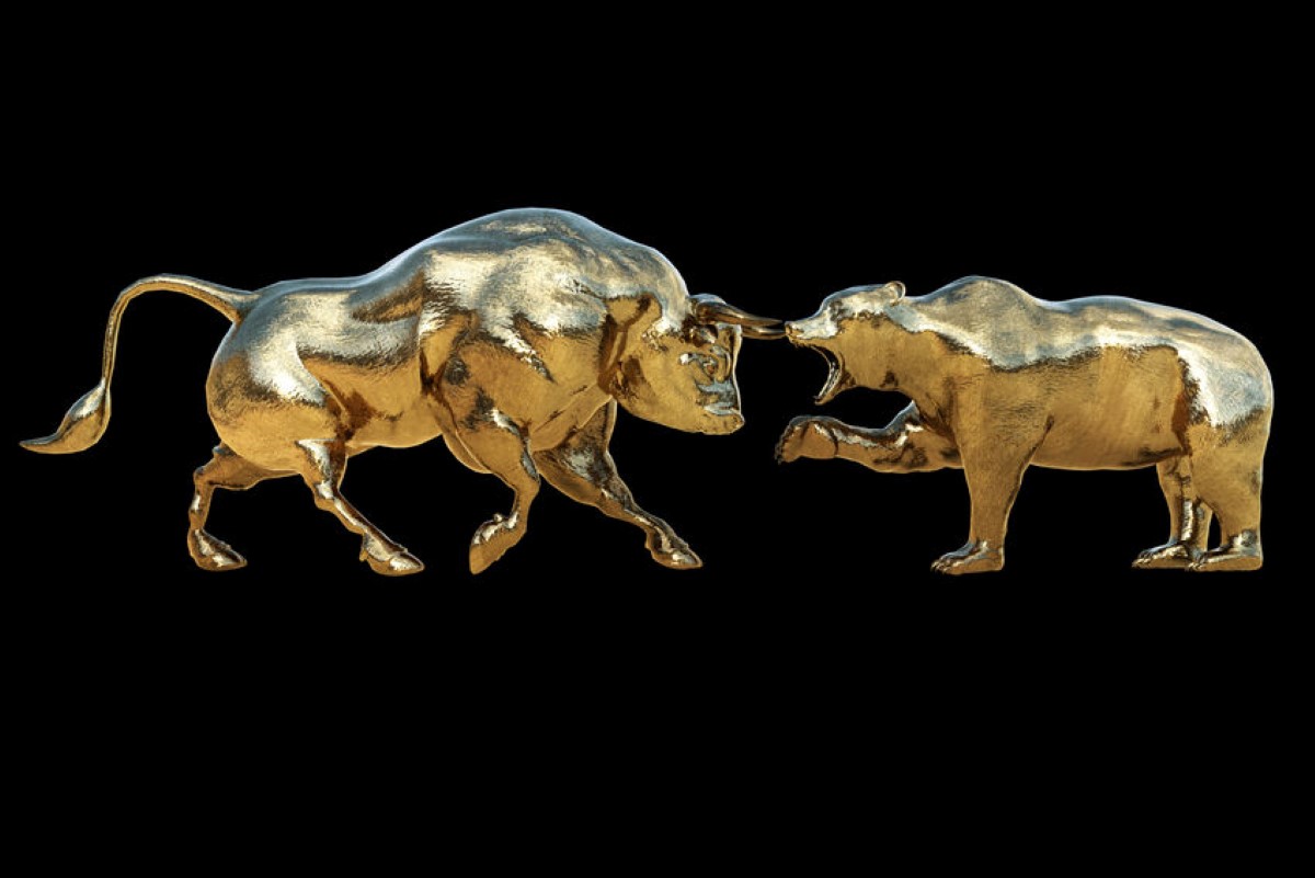 a gold bull and bear facing each other