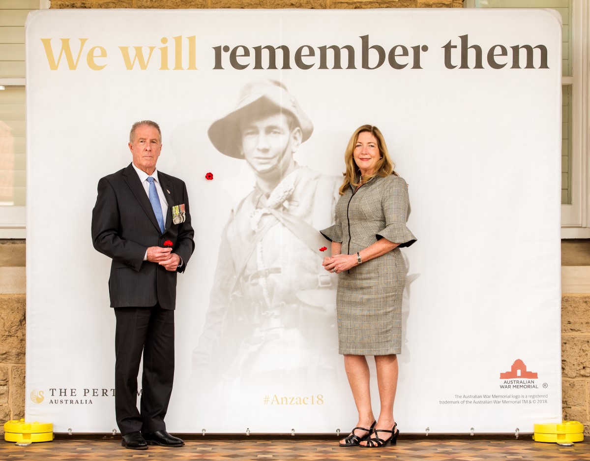 Mr John McCourt, Chief Executive Officer RSLWA places the first poppy on The Perth Mint Centenary Poppy Wall of remembrance with Alison Puchy, Perth Mint Group Manager, Shop and Exhibition.