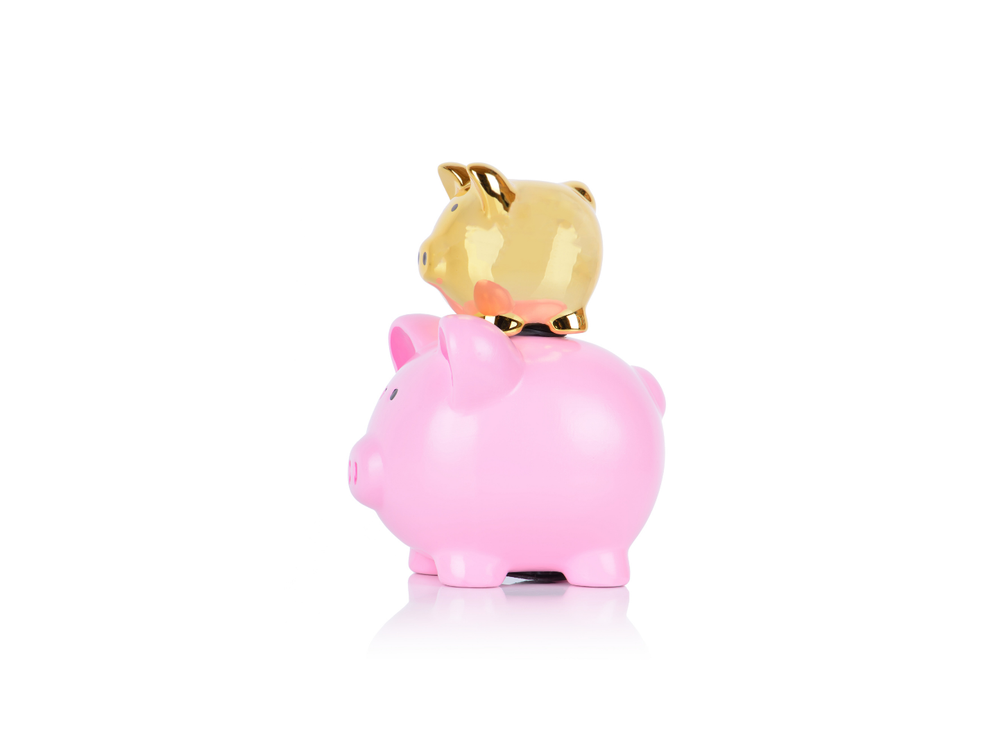 a pink piggy bank with a smaller gold piggy bank on top