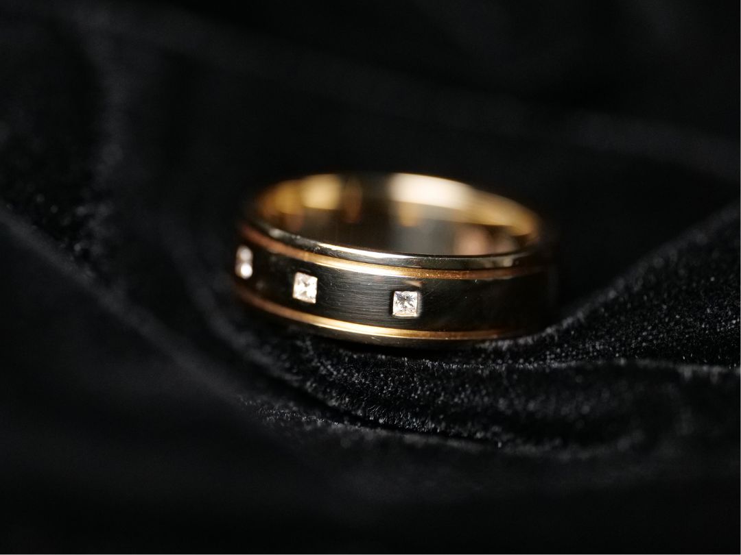 A hammer or flush-set wedding band with diamonds encased flush in the ring.