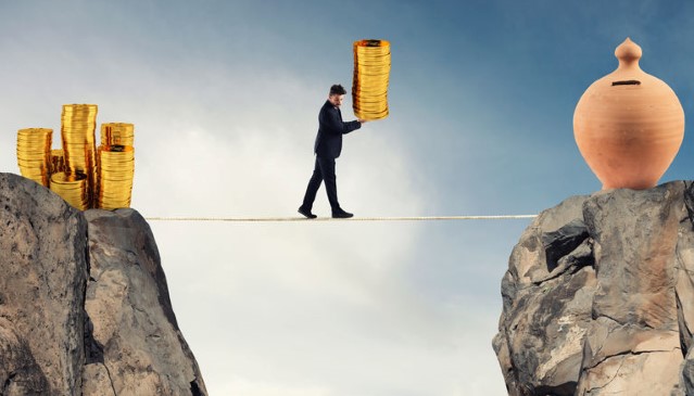 a man on a tightrope carrying coins