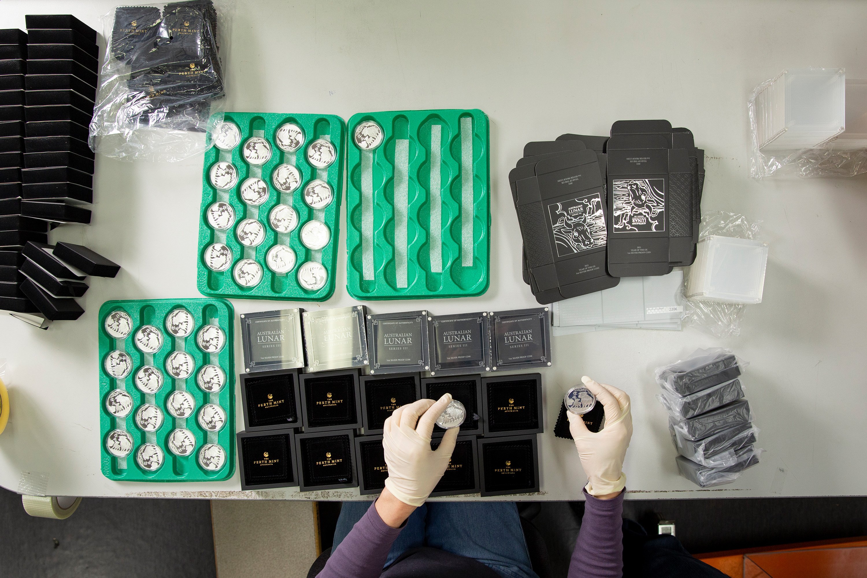 Preparing coins for sale at The Perth Mint.