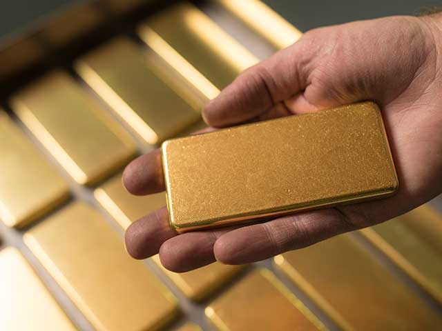 Gold bar in hand at The Perth Mint refinery.