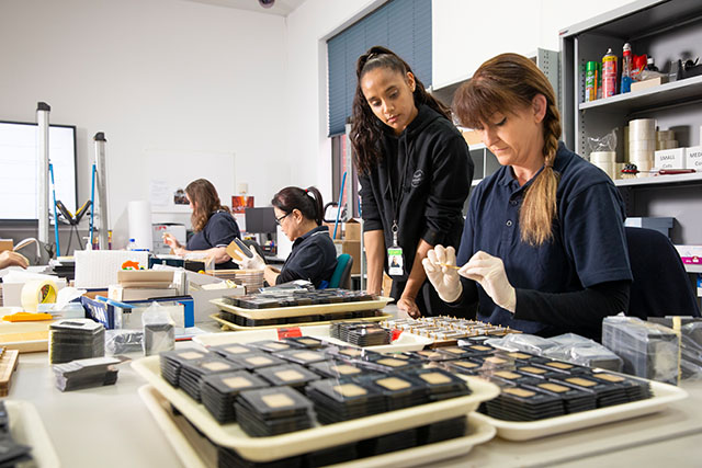 Staff package coins ready for shipping at The Perth Mint.