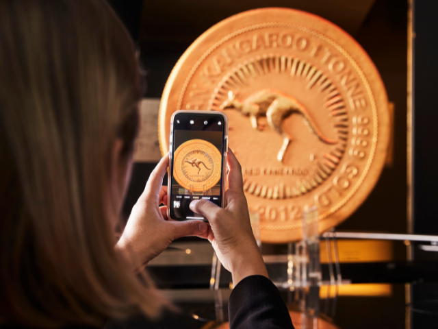 a person taking a photo of The Perth Mint One tonne coin