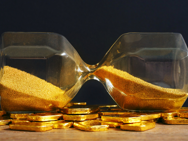 a gold hourglass with gold coins