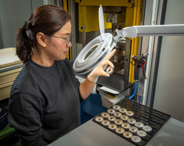 an image of a Perth Mint worker inspecting a coin