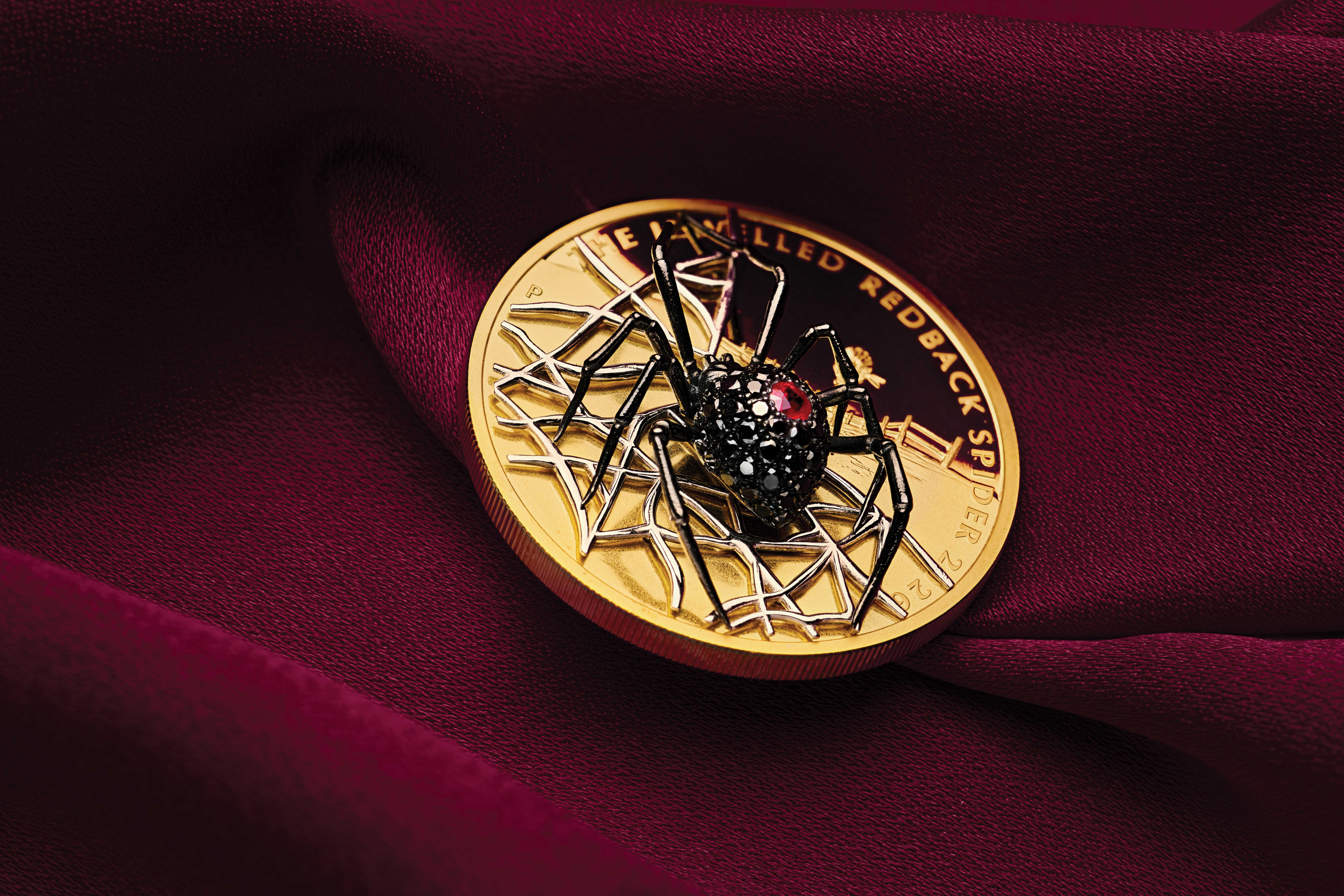 Jewelled Redback coin on red velvet