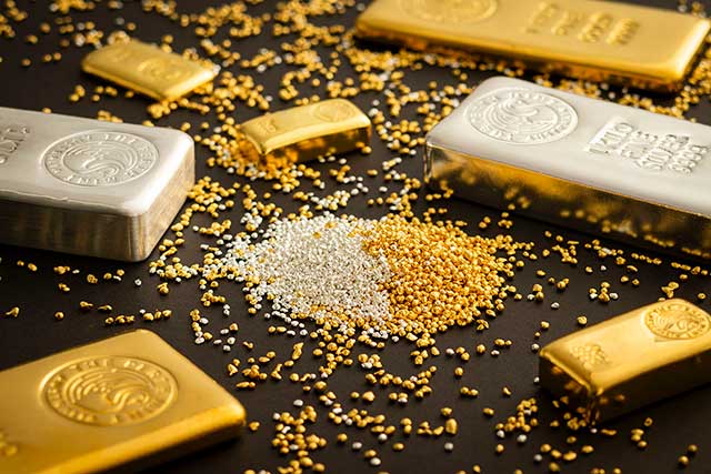 The Perth Mint gold and silver bars on a black background amongst gold and silver granules