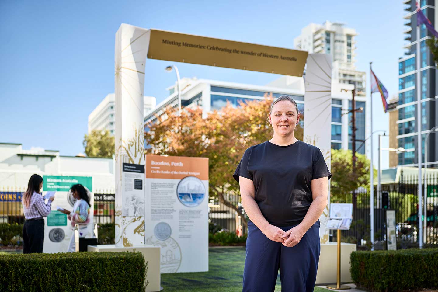 Perth Mint Curator, Natasha Fenner in front of the exhibit display